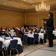 Sarita Maybin on stage speaking to CMAA, LLC
